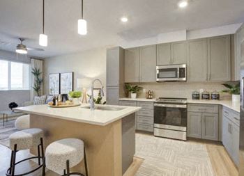 a kitchen with a center island next to a stove top oven